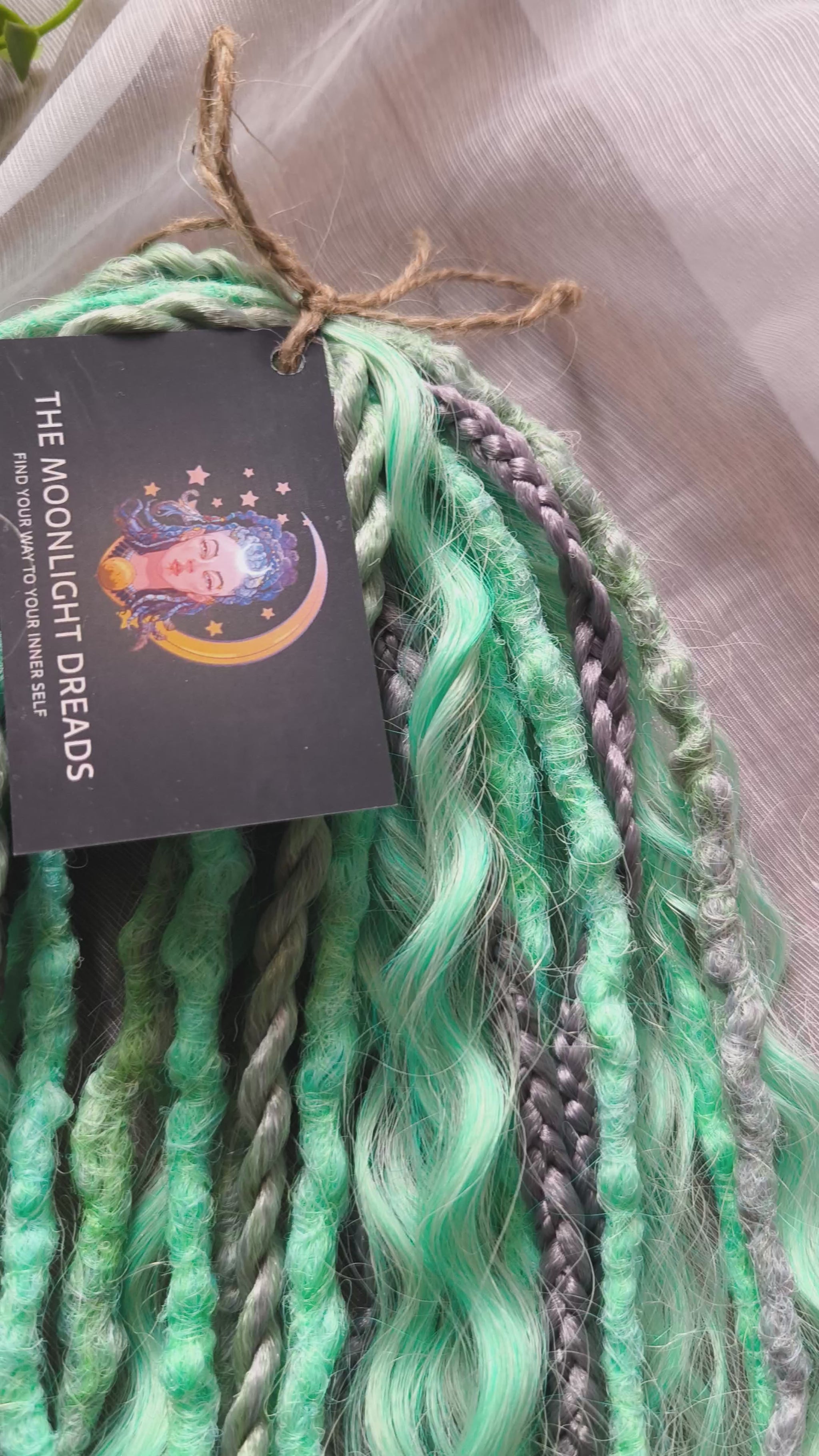 Silver Mint: soft, lightweight, and reusable 20 double ended synthetic crochet dreadlocks, braids, and non-brushable curls in a soft blend of silver and aquamarine.
