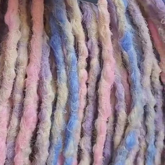 Pastel Cloud - a soft pastel mix of lavender, baby blue, blush pink, and creamy blonde. Soft, lightweight, and reusable 49 double ended synthetic bumpy dreadlocks with blunt ends give a calm, airy look.

Length: ≈15-16 inches (≈38-40 cm)
Thickness of dreads and braids: ≈0.8-1 cm
Weight: ≈260 gr (≈9,17 oz)