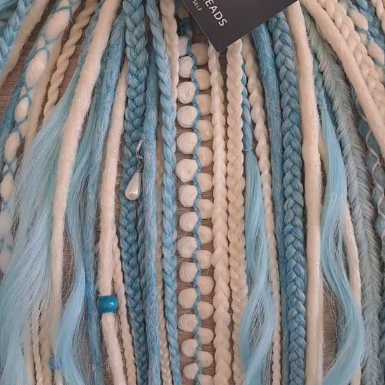 Ice Flow is a soft, lightweight, and reusable set of double ended synthetic crochet dreadlocks, various braids, and dreaded curls. A fresh blend of icy blue and soft white with a smooth, airy flow of color.

Standard length: 22-24 inches (55-60 cm)
Thickness of dreads and braids: ~0.8 cm
Dreaded part of curls ~3-4 inches (8-10 cm)