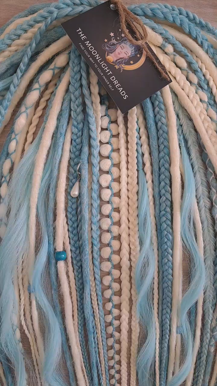 Ice Flow is a soft, lightweight, and reusable set of double ended synthetic crochet dreadlocks, various braids, and dreaded curls. A fresh blend of icy blue and soft white with a smooth, airy flow of color.

Standard length: 22-24 inches (55-60 cm)
Thickness of dreads and braids: ~0.8 cm
Dreaded part of curls ~3-4 inches (8-10 cm)
