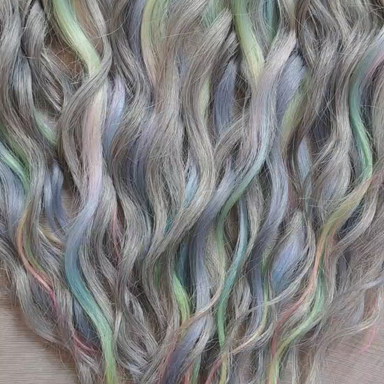 Moon Pearl - soft, lightweight, and reusable synthetic brushable double ended wavy dreadlocks (regular dreaded, braided middle, or push-up).

A blend of pearl grey, icy blue, soft mint, lavender, and blush pink - subtle, airy, and full of depth. The pastel shades appear gently throughout the set, creating a shimmering effect without overpowering the base color.
