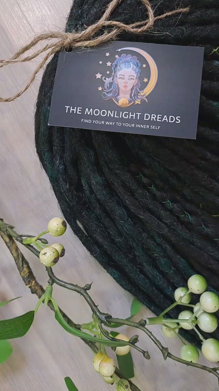 Deep forest dreads - Black and ombre emerald synthetic set of 50 double ended crochet dreadlocks.

Length: ±18-20 inches (45-50 cm)
Thickness of dreads and braids: ±0.8-1 cm
Weight with decoration: ±315 gr (11 oz)