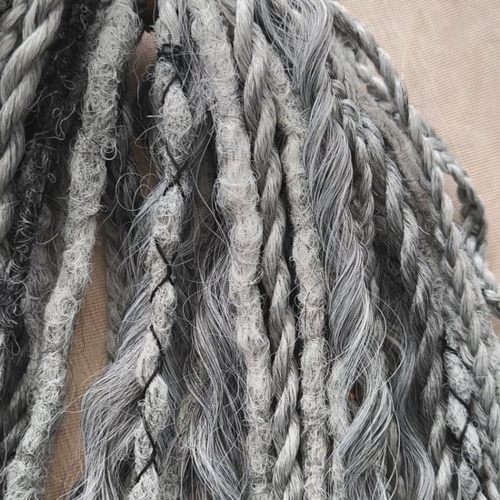 This set of synthetic dreadlocks combines elements of a Viking-inspired aesthetic.
Ombre from grey to platinum blonde double ended crochet dreads, braids, and Senegalese twists (curls optionally). Decoration is included. Reusable lightweight set made from high-quality synthetic hypoallergenic material kanekalon.

Standard length: ±22-24 inches (55-60 cm)
Thickness of dreads and braids: ±0.8 cm
Dreaded part of curls: ±3-4 inches (8-10 cm)
