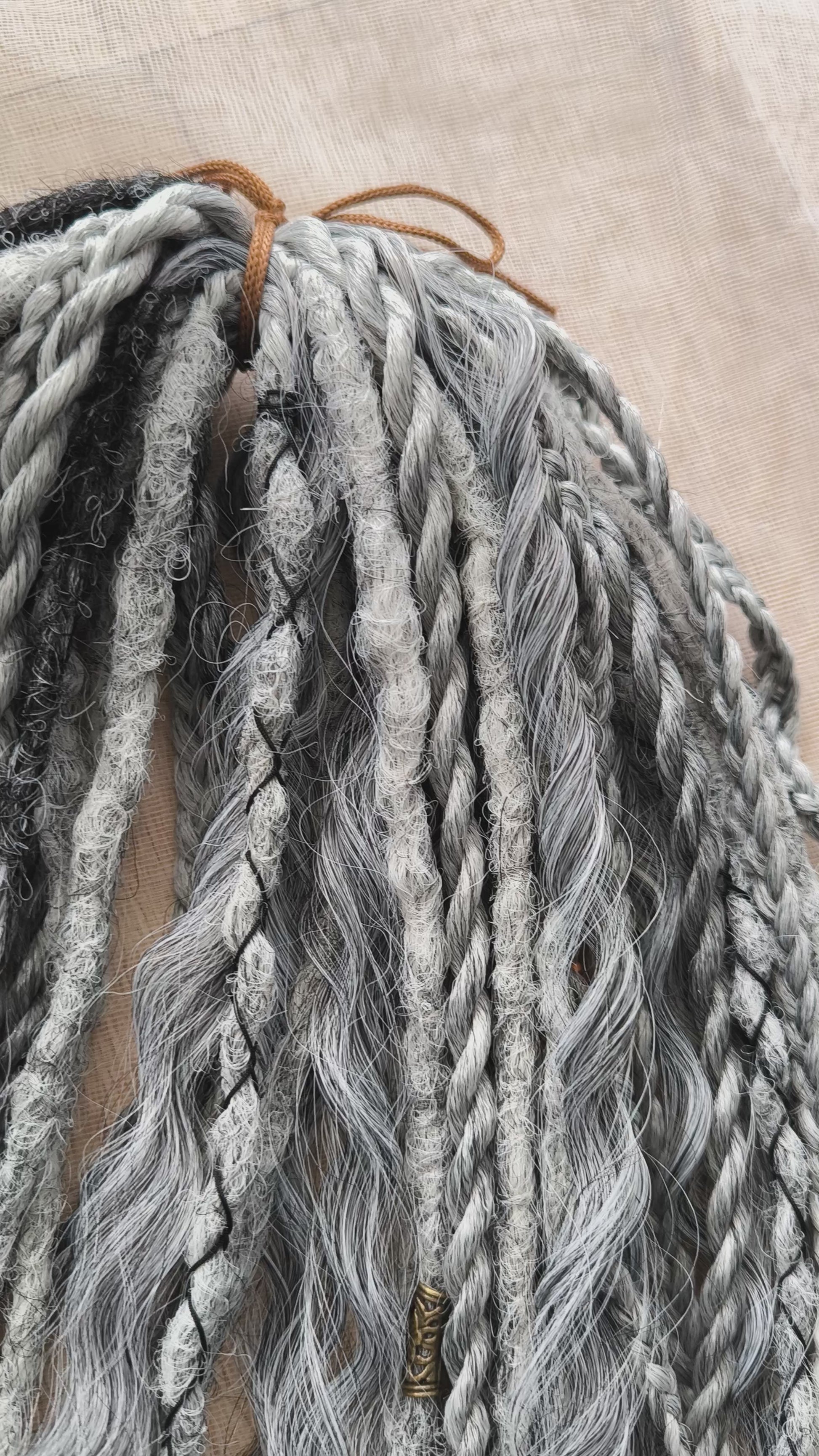 This set of synthetic dreadlocks combines elements of a Viking-inspired aesthetic.
Ombre from grey to platinum blonde double ended crochet dreads, braids, and Senegalese twists (curls optionally). Decoration is included. Reusable lightweight set made from high-quality synthetic hypoallergenic material kanekalon.

Standard length: ±22-24 inches (55-60 cm)
Thickness of dreads and braids: ±0.8 cm
Dreaded part of curls: ±3-4 inches (8-10 cm)