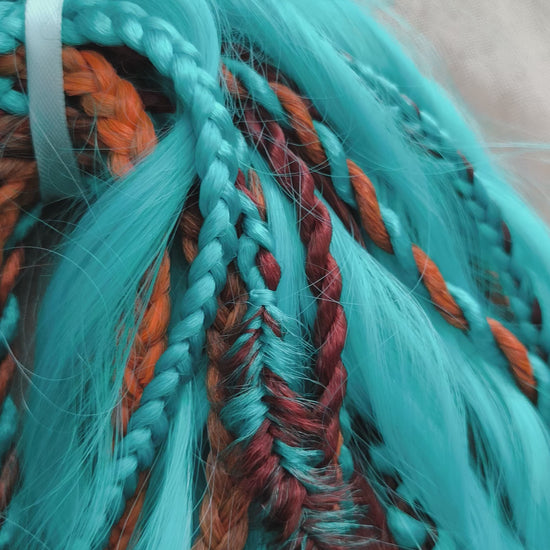 Ginger Sky: soft, lightweight, and reusable double ended various DE synthetic braids and regular dreaded brushable curls. A mix of turquoise green, red, copper, and orange colors.

The length is 22-24 inches (55-60 cm)
Dreaded part of curls: 4-5 inches
Thickness of braids ±0.8 cm