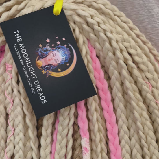 Vanilla Rose - a soft, lightweight, and reusable set of DE synthetic braids in creamy vanilla blonde, beige, and soft pink shades