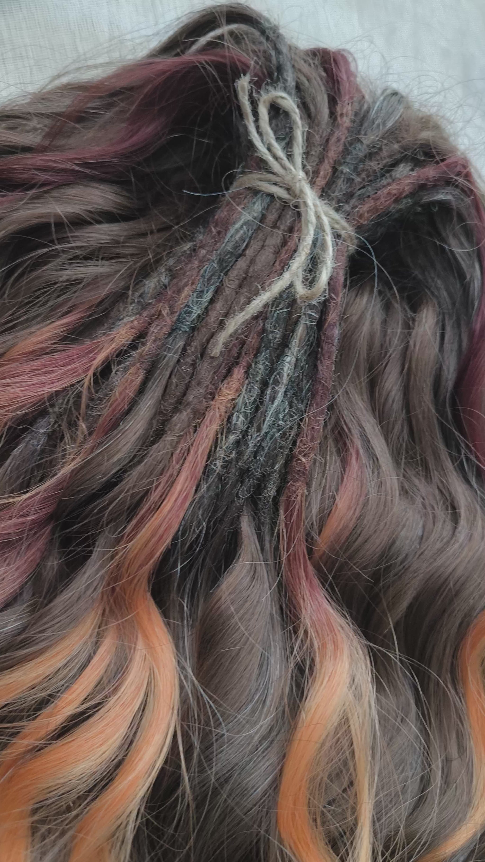 This moody, elegant set of soft, lightweight, and reusable synthetic brushable double-ended wavy dreadlocks features 2 shades of brown as the main color, enriched with calico strands. 