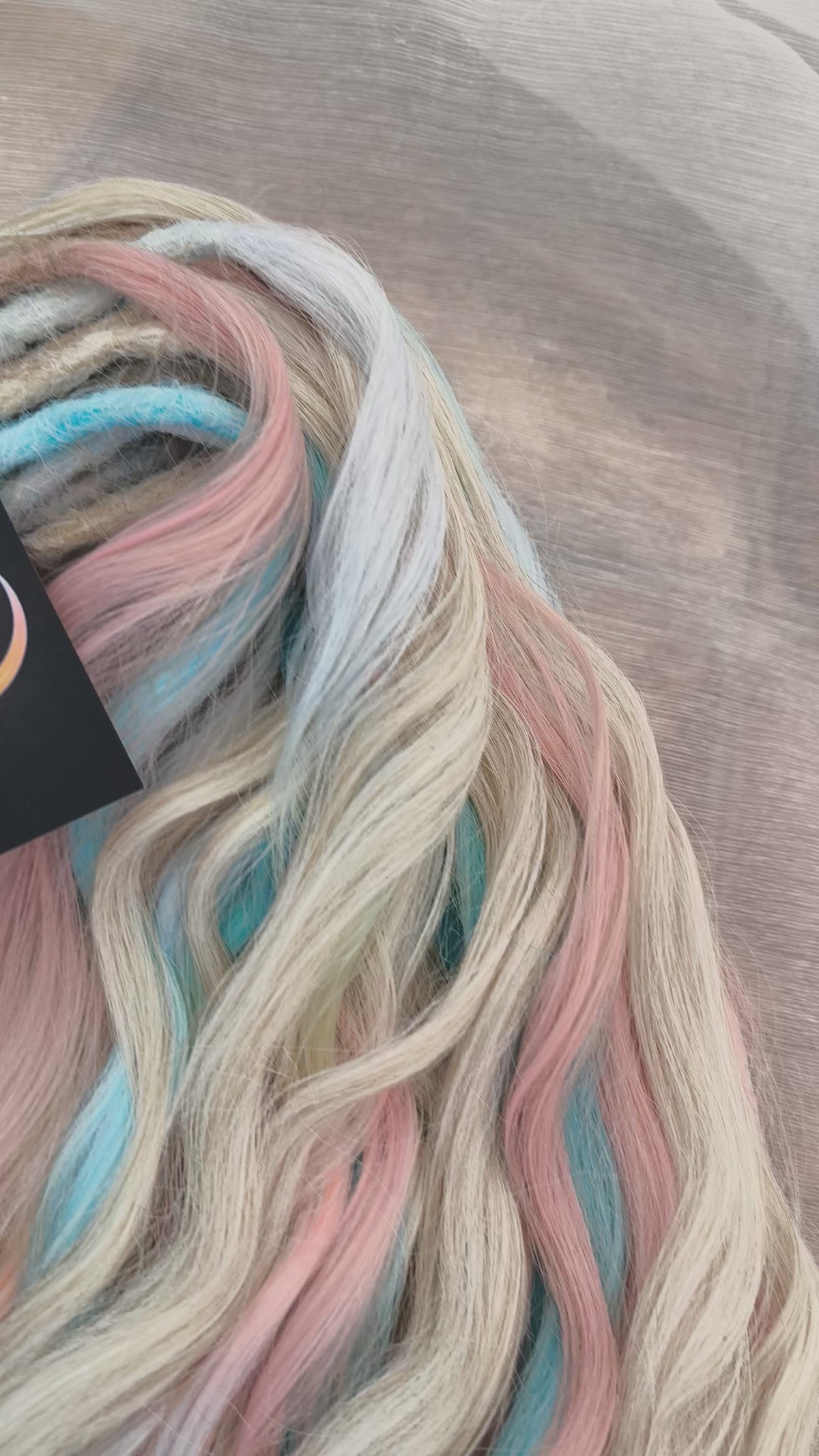 Second Life: Cotton Candy - 50 DE synthetic regular dreaded brushable curls (one-side dreaded part). A blend of platinum blonde, sky blue, pink, and rainbow colors.  Worn once . Has been washed and corrected. Good condition (a bit damaged ends).