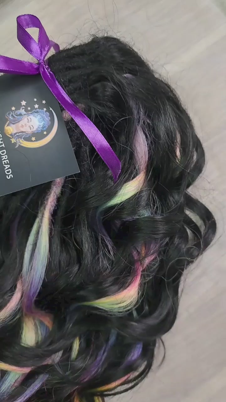 Black Rainbow - 60 DE soft, lightweight, and reusable synthetic standard dreaded brushable curls Manasi. Black base blended with rainbow/prism/glitch effect accents. 

Length: 16 inches (40 cm)
Dreaded part: approximately 3-4 inches (8-10 cm)
Weight: ±300 gr (10,6 oz)
