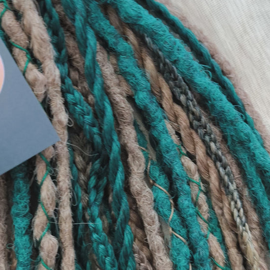 synthetic set of double ended crochet dreadlocks, braids, Senegalese twists in forest green and a few tints of brown colors.