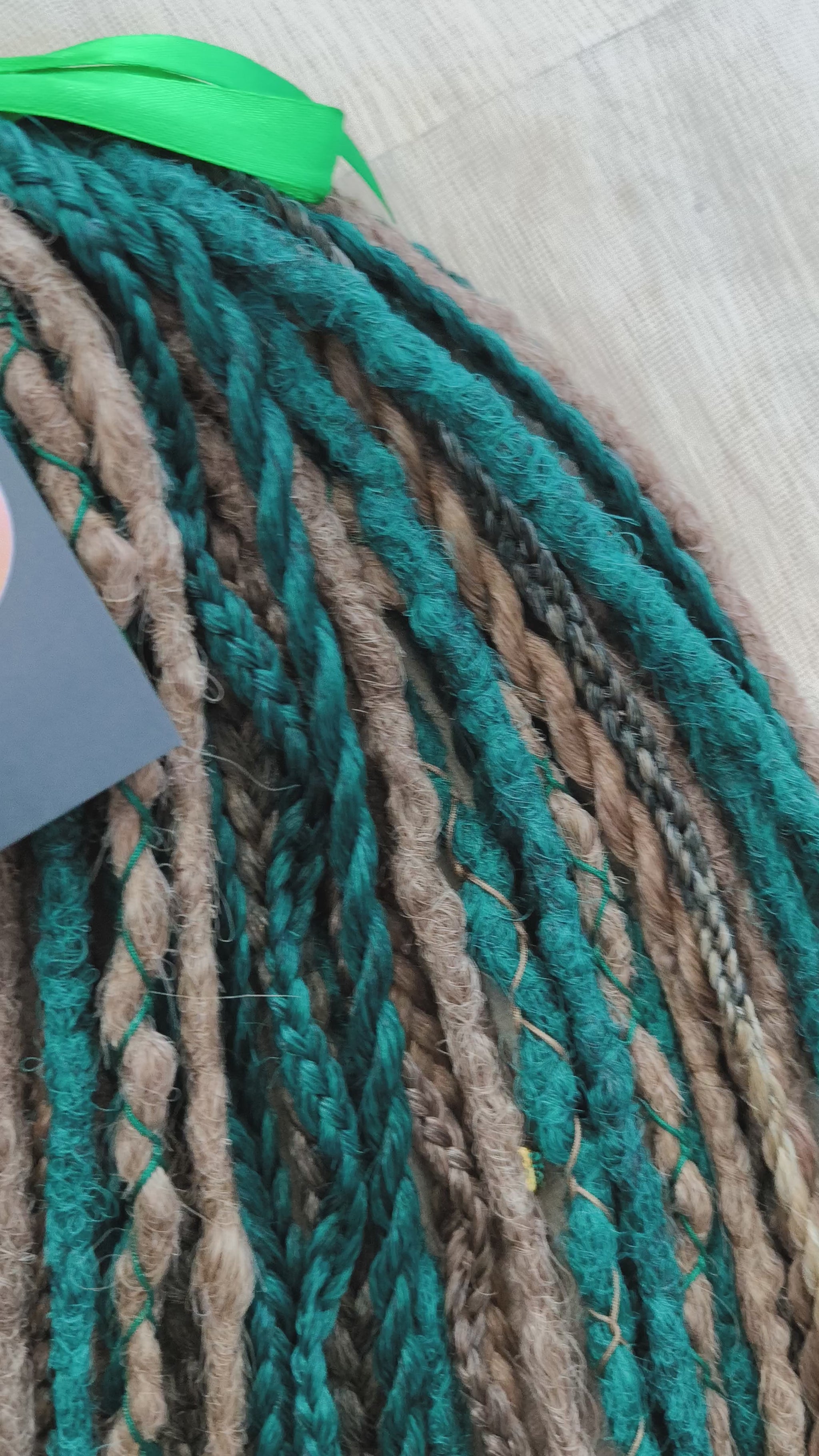 synthetic set of double ended crochet dreadlocks, braids, Senegalese twists in forest green and a few tints of brown colors.