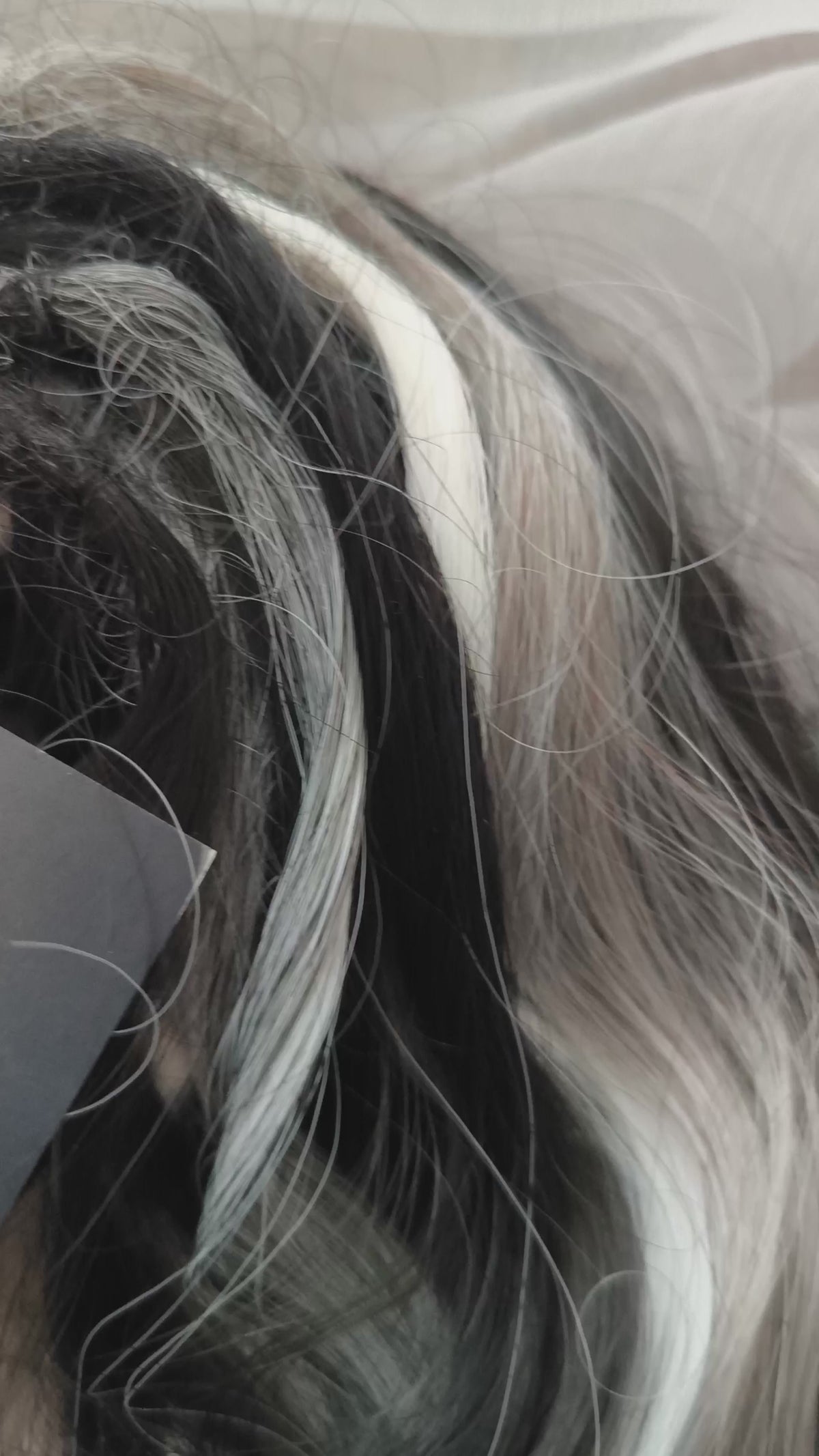 Silver Raven - 50 double ended ready-to-ship black, silver-grey, and white synthetic brushable wavy dreadlocks. Soft, lightweight, and reusable, a monochromatic blend with a dark, mysterious, witchy feel. Your spooky season look starts here

