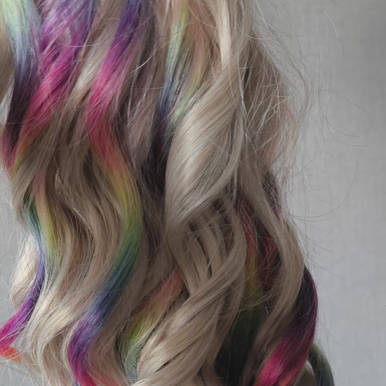 White Rainbow - 60 DE soft, lightweight, and reusable synthetic standard dreaded brushable curls Manasi. Platinum blonde base blended with rainbow/prism/glitch effect accents. 

Length: 16 inches (40 cm)
Dreaded part: approximately 3-4 inches (8-10 cm)
Weight: ±300 gr (10,6 oz)