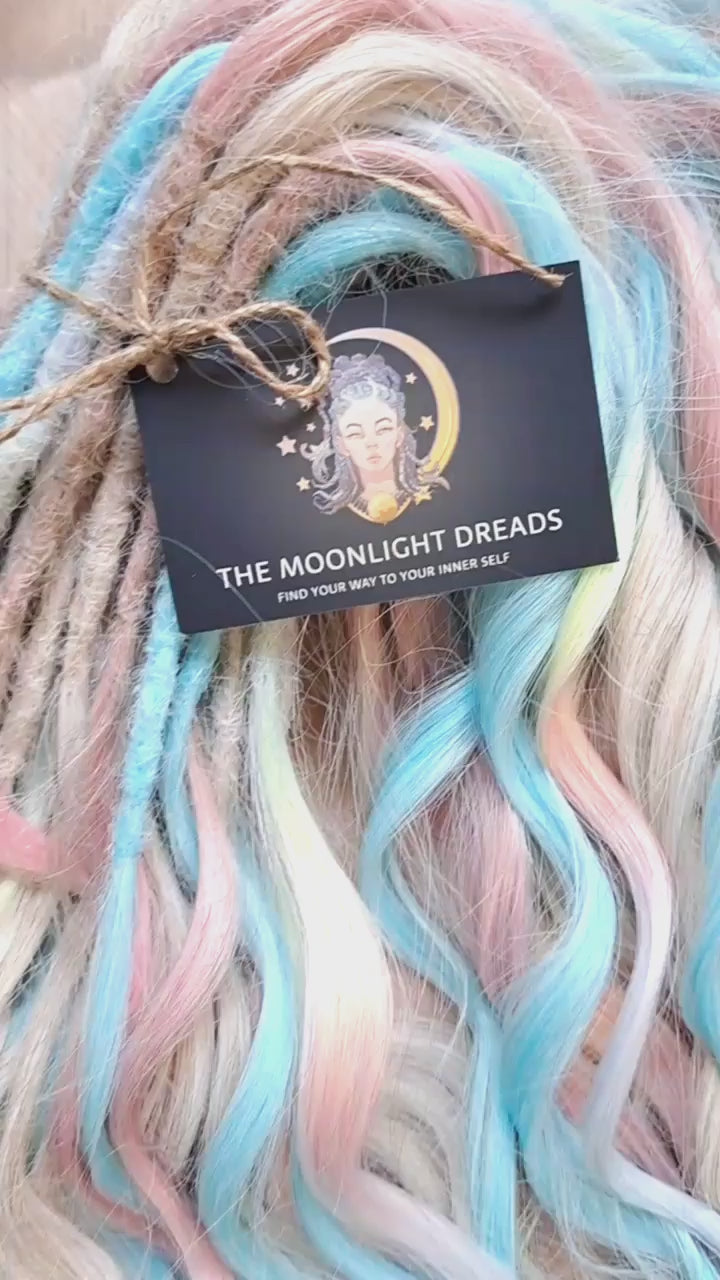 Ready to Ship: Cotton Candy - soft, lightweight, and reusable 50 double ended synthetic brushable dreaded curls. A blend of platinum blonde, sky blue, pink, and rainbow colors creates a light, airy look full of soft color transitions.

Length: 22-24 inches (55-60 cm)
Dreaded part (one-side dreaded): ±4-5 inches (±10-12 cm)
Weight: ±300 gr (10,6 oz)