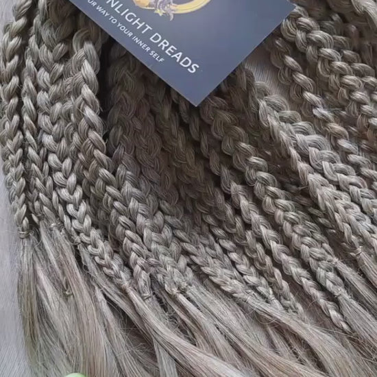 Ready to ship: soft, lightweight, and reusable 50 double ended synthetic brushable curls with braided middle. Soft natural gradient in warm neutral tones.

Roots in muted dark blonde with a subtle ash-beige (taupe) undertone, gradually blending into a warm beige-wheat blonde, and finishing in a light creamy, almost platinum vanilla blonde at the ends.