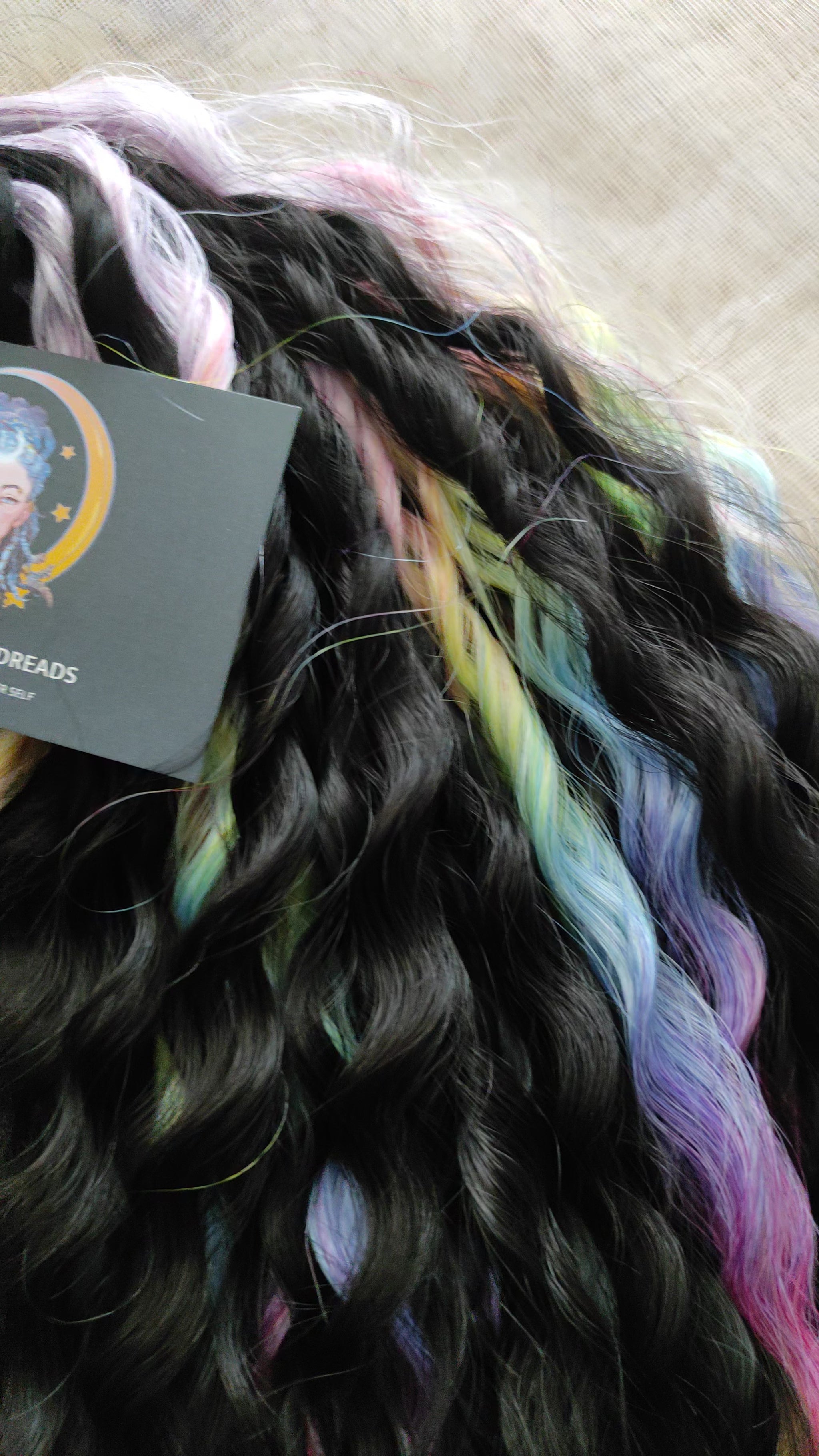 The mix of Black and Rainbow/glitch/prism effect soft, lightweight, and reusable synthetic brushable double ended wavy dreadlocks (NOT BRUSHABLE).