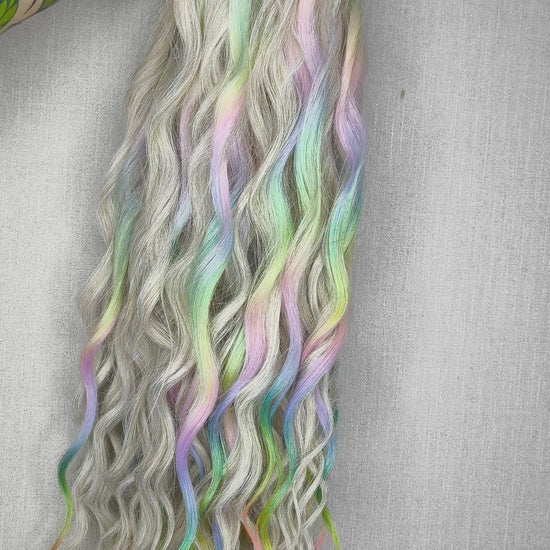 The mix of Platinum blonde and Rainbow/glitch/prism effect (2/3 parts of blonde + 1/3 part of rainbow) soft, lightweight, and reusable synthetic brushable double ended wavy dreadlocks (regular dreaded or push-up).