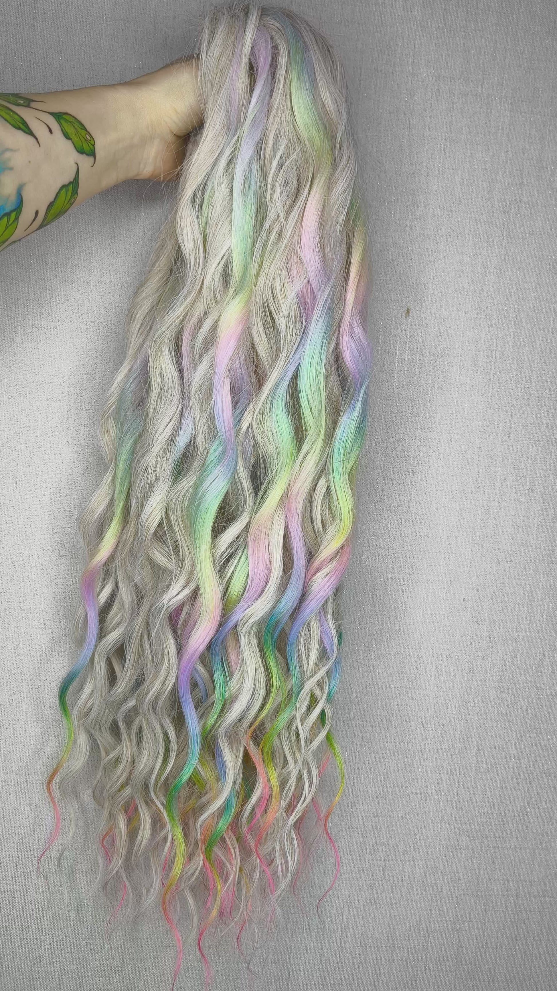 The mix of Platinum blonde and Rainbow/glitch/prism effect (2/3 parts of blonde + 1/3 part of rainbow) soft, lightweight, and reusable synthetic brushable double ended wavy dreadlocks (regular dreaded or push-up).