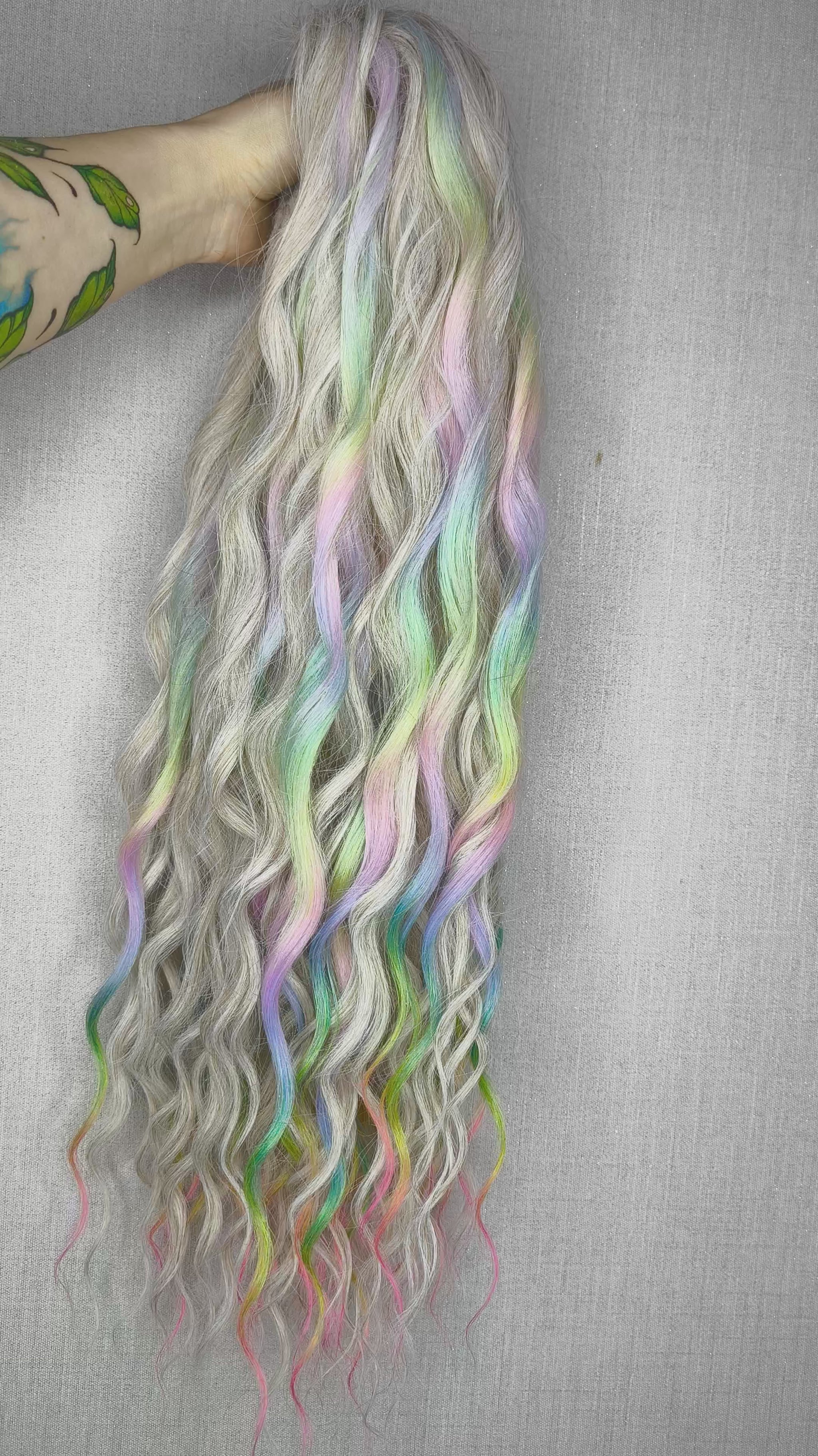 The mix of Platinum blonde and Rainbow/glitch/prism effect (2/3 parts of blonde + 1/3 part of rainbow) soft, lightweight, and reusable synthetic brushable double ended wavy dreadlocks (regular dreaded or push-up).