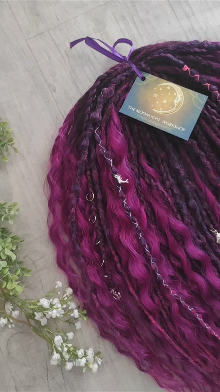 A rich, saturated magenta shade with deep berry and purple undertones. The color shifts between dark fuchsia, plum, and wine tones, creating depth and dimension throughout the set.  Soft, lightweight, and reusable double ended braids, Senegalese twists, and non-brushable dreaded curls.

Standard length: ±22-24 inches (55-60 cm)
Thickness of dreads and braids: ±0.8 cm
Dreaded part of curls ±8-10 cm (3-4 inches)