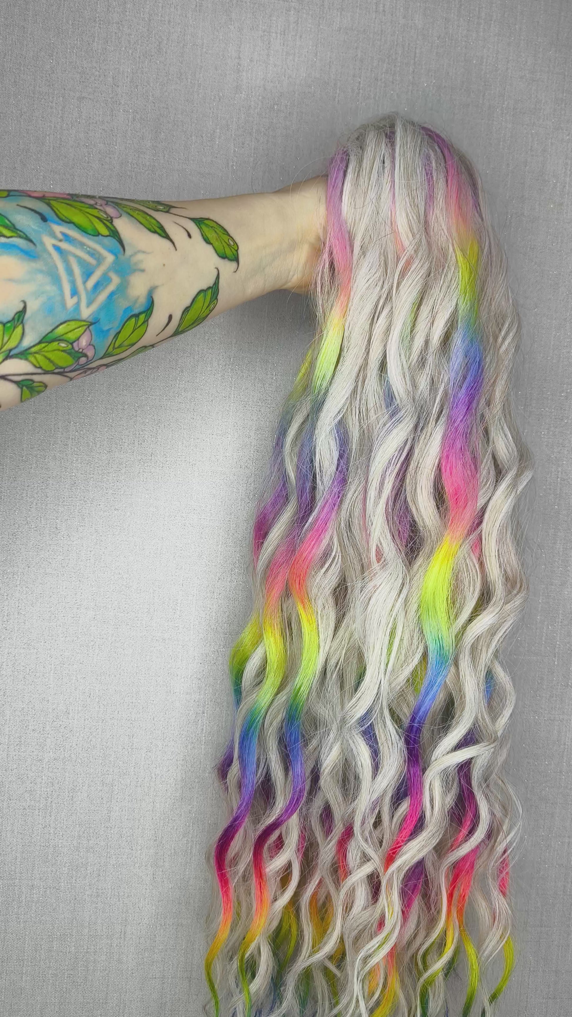 The mix of Platinum blonde and Rainbow/glitch/prism effect (2/3 parts of blonde + 1/3 part of rainbow) soft, lightweight, and reusable synthetic brushable double ended wavy dreadlocks (regular dreaded or push-up).