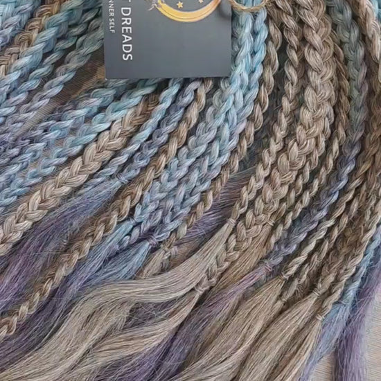 Soft, lightweight, and reusable double ended synthetic brushable curls. Ombre from ash to platinum blonde, and a cool transition from dusty blue into lavender and navy blue.