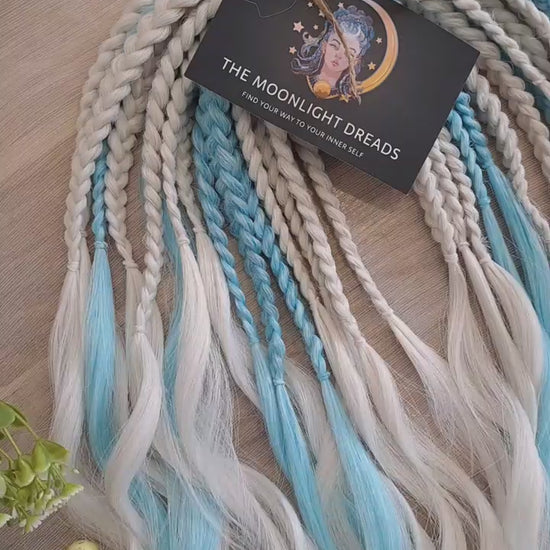 Step into a winter fairytale with "Frozen" - a dreamy blend of icy blue and snow-white shades. This set feels like a breath of frosty air and glows with cool, magical vibes. Soft, lightweight, and reusable synthetic brushable double ended wavy dreadlocks (regular dreaded, braided middle, or push-up). Let your style sparkle with a chill ❄️