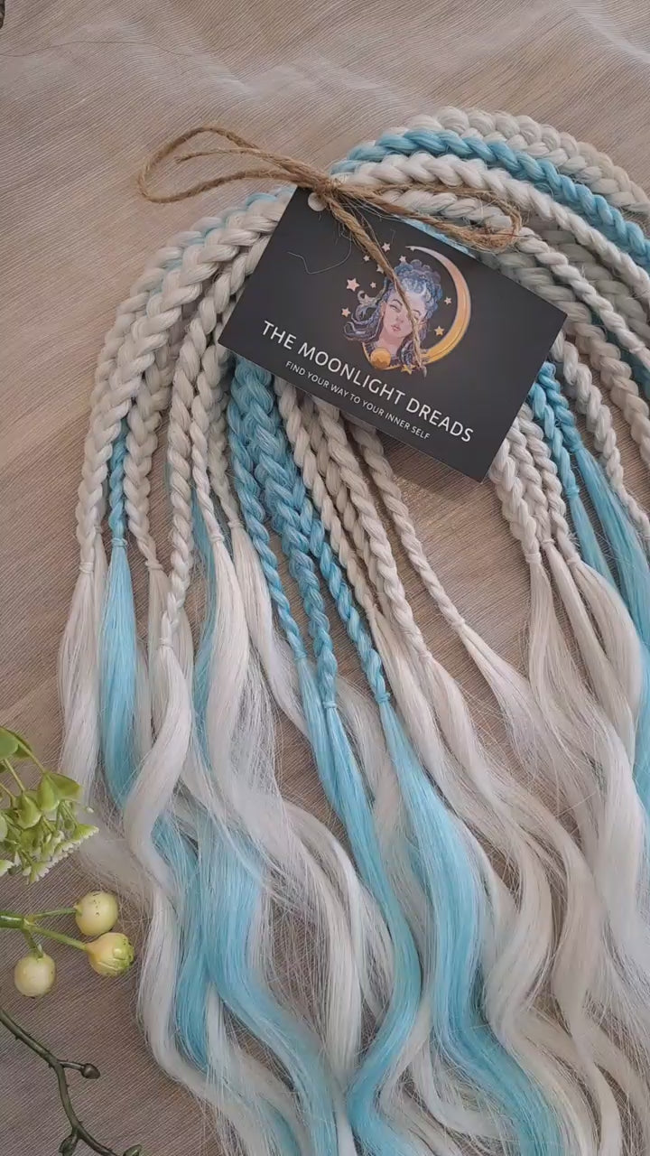 Step into a winter fairytale with "Frozen" - a dreamy blend of icy blue and snow-white shades. This set feels like a breath of frosty air and glows with cool, magical vibes. Soft, lightweight, and reusable synthetic brushable double ended wavy dreadlocks (regular dreaded, braided middle, or push-up). Let your style sparkle with a chill ❄️