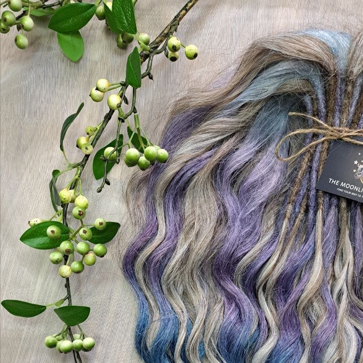 Soft, lightweight, and reusable double ended synthetic brushable curls. Ombre from ash to platinum blonde, and a cool transition from dusty blue into lavender and navy blue.