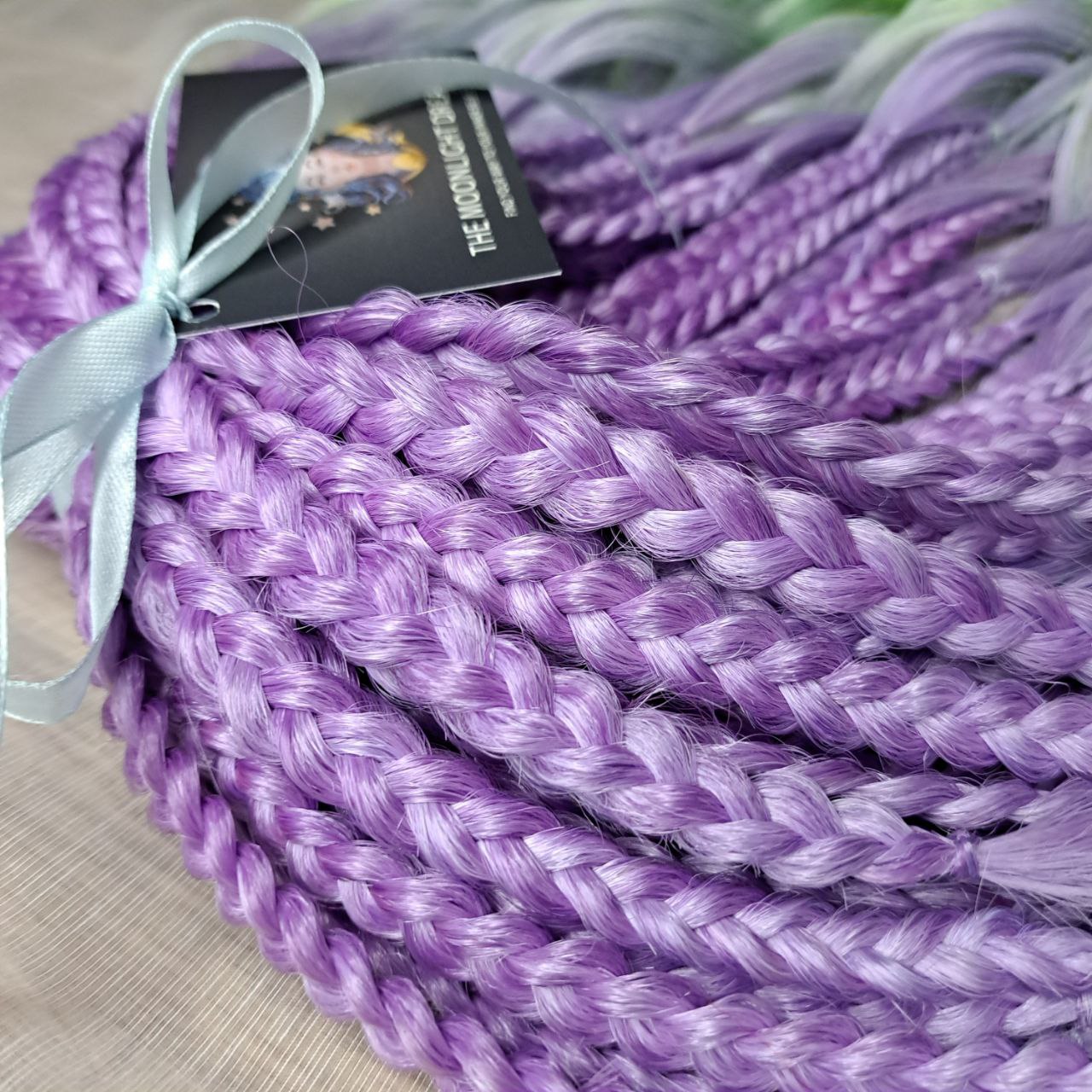 ombre from purple/lavender to light green and yellow brushable curls with braided middle 