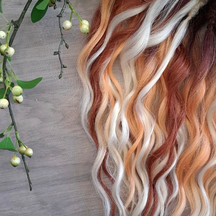 This set combines a rich three-tone ombré gradient — deep chestnut, warm copper, and pale blonde — with additional solid strands in copper and creamy platinum, creating a stunning play of light and color.

Inspired by autumn leaves, glowing embers, and the graceful energy of a wild fox, Amber Fox is made to stand out with both softness and strength.

Soft, lightweight, and reusable synthetic brushable double ended wavy dreadlocks (available as regular dreaded, braided middle, or push-up).