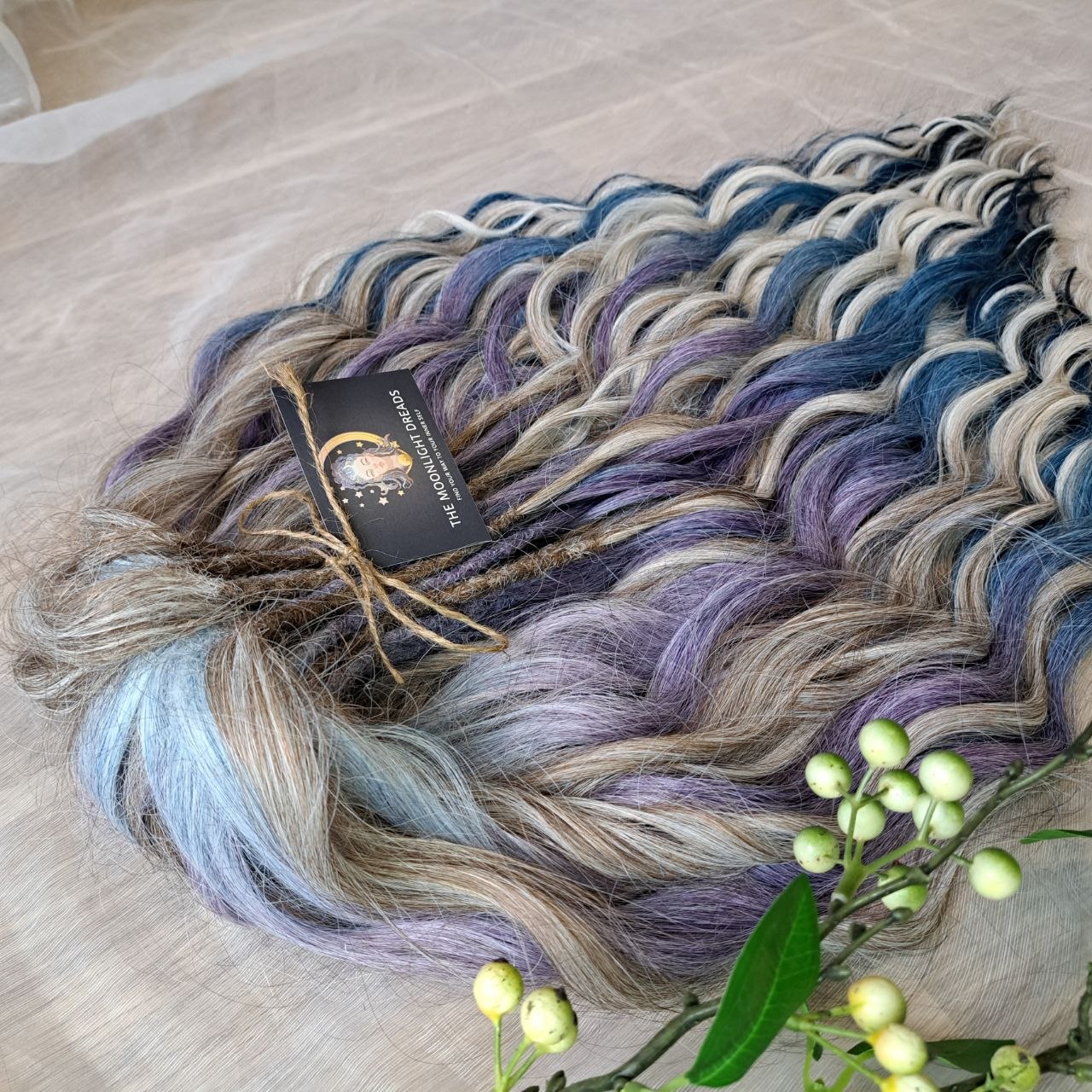 Soft, lightweight, and reusable double ended synthetic brushable curls. Ombre from ash to platinum blonde, and a cool transition from dusty blue into lavender and navy blue.
