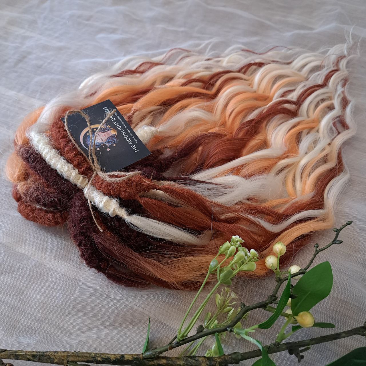 This set combines a rich three-tone ombré gradient — deep chestnut, warm copper, and pale blonde — with additional solid strands in copper and creamy platinum, creating a stunning play of light and color.

Inspired by autumn leaves, glowing embers, and the graceful energy of a wild fox, Amber Fox is made to stand out with both softness and strength.

Soft, lightweight, and reusable synthetic brushable double ended wavy dreadlocks (available as regular dreaded, braided middle, or push-up).
