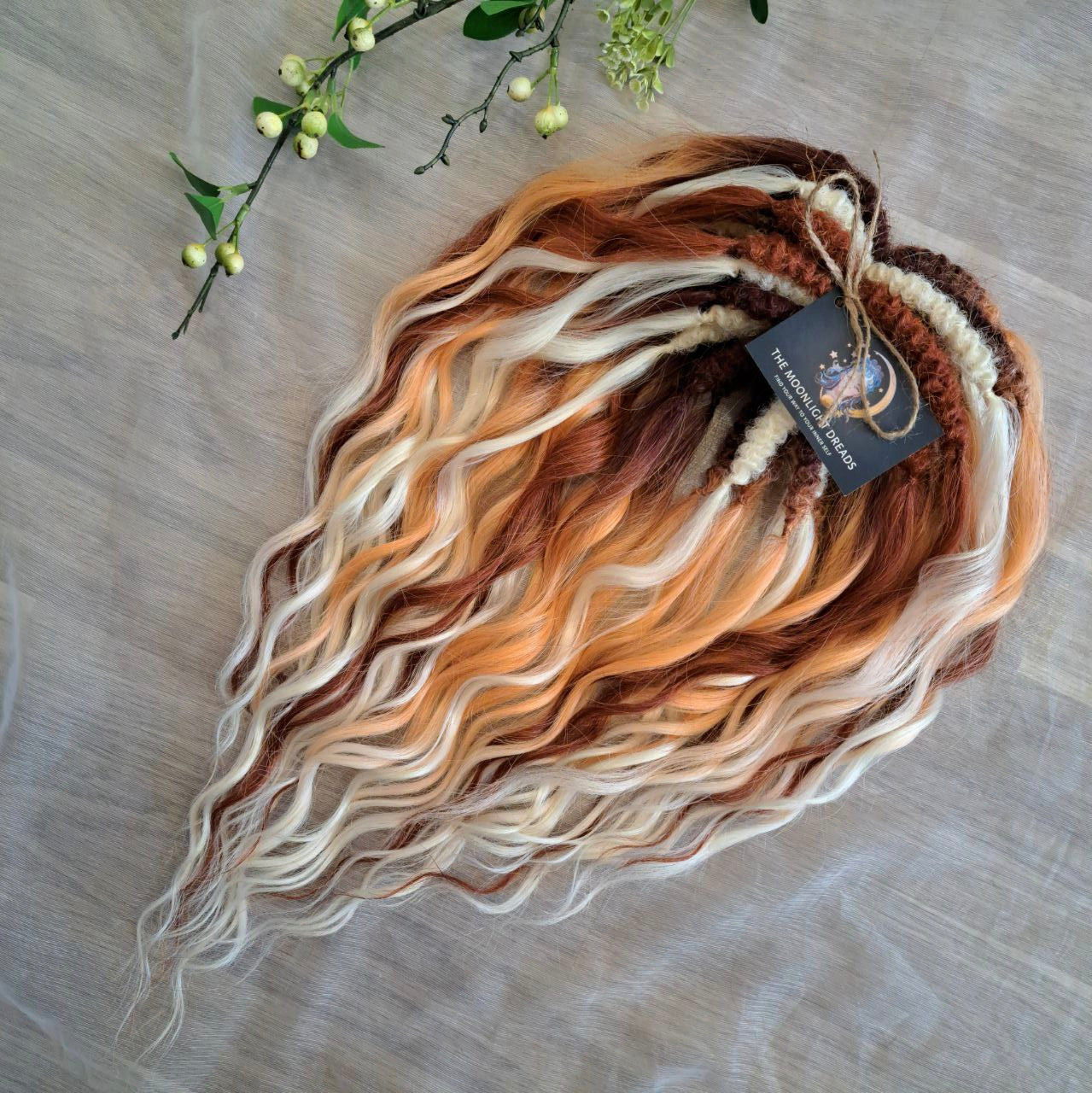 This set combines a rich three-tone ombré gradient — deep chestnut, warm copper, and pale blonde — with additional solid strands in copper and creamy platinum, creating a stunning play of light and color.

Inspired by autumn leaves, glowing embers, and the graceful energy of a wild fox, Amber Fox is made to stand out with both softness and strength.

Soft, lightweight, and reusable synthetic brushable double ended wavy dreadlocks (available as regular dreaded, braided middle, or push-up).