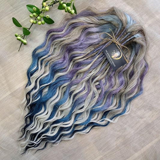 Soft, lightweight, and reusable double ended synthetic brushable curls. Ombre from ash to platinum blonde, and a cool transition from dusty blue into lavender and navy blue.
